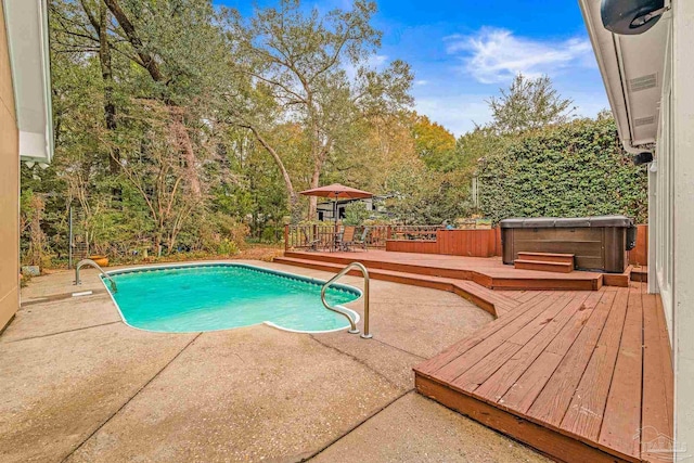 view of swimming pool with a patio area, a hot tub, and a deck