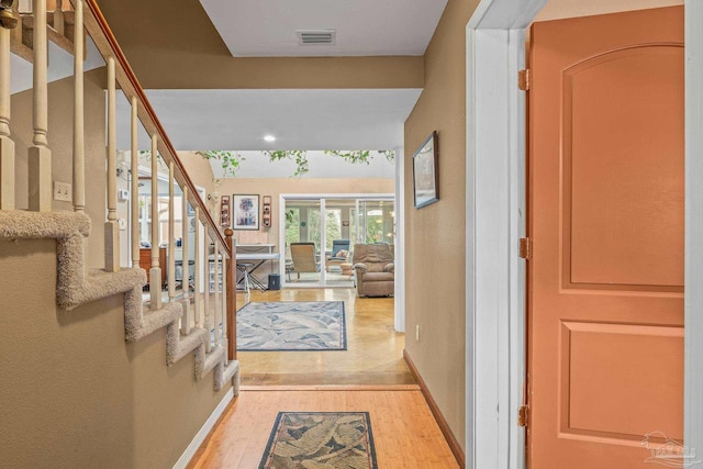 corridor with light hardwood / wood-style flooring