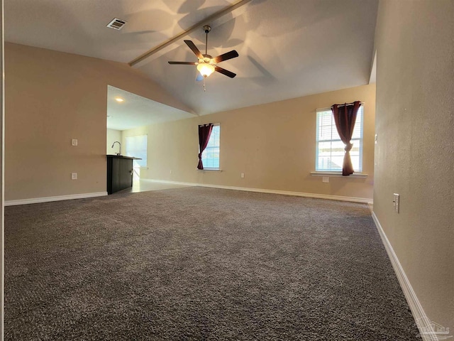 empty room featuring dark colored carpet, ceiling fan, lofted ceiling, and sink