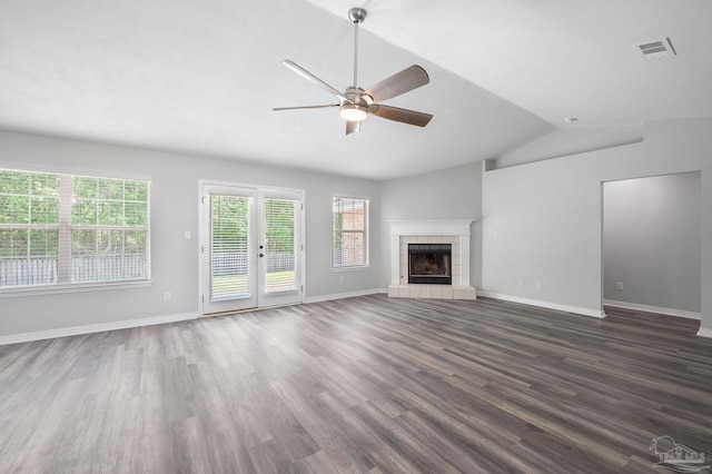 unfurnished living room with dark wood-style flooring, a fireplace, lofted ceiling, a ceiling fan, and baseboards