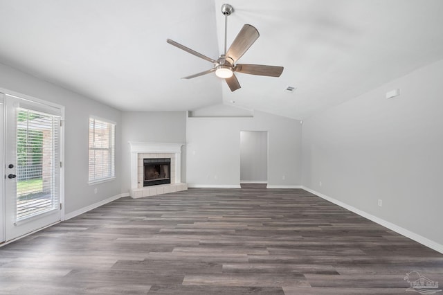 unfurnished living room featuring a tile fireplace, visible vents, a ceiling fan, baseboards, and dark wood-style floors