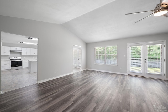 unfurnished living room featuring a ceiling fan, baseboards, vaulted ceiling, and wood finished floors