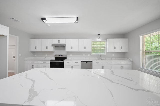 kitchen featuring appliances with stainless steel finishes, visible vents, under cabinet range hood, and light stone counters