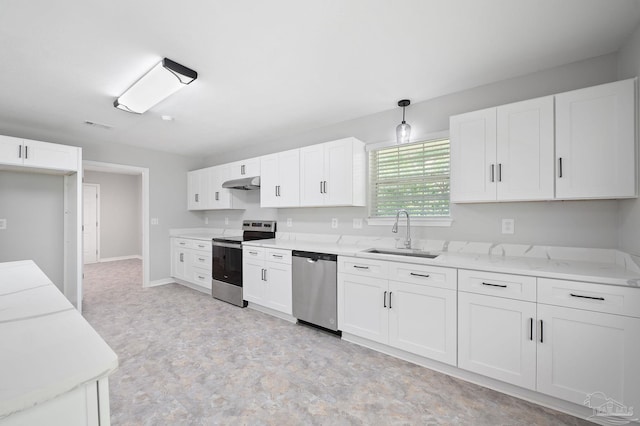 kitchen featuring appliances with stainless steel finishes, hanging light fixtures, under cabinet range hood, white cabinetry, and a sink