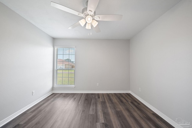 unfurnished room featuring dark wood finished floors, baseboards, and ceiling fan