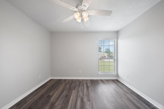 empty room featuring a ceiling fan, baseboards, and dark wood-type flooring