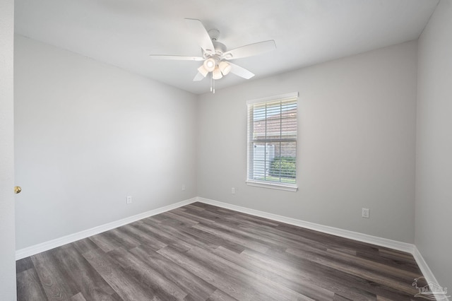 empty room featuring dark wood-style floors, ceiling fan, and baseboards