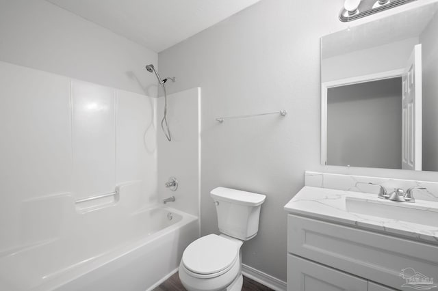 bathroom featuring tub / shower combination, vanity, and toilet