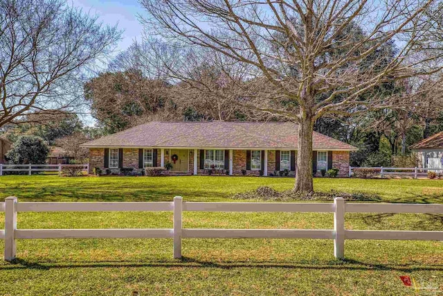 ranch-style house featuring a fenced front yard and a front yard