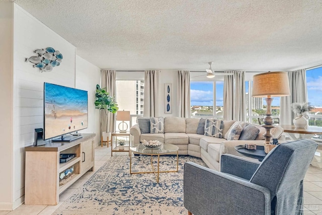 living room with a textured ceiling and light tile patterned floors