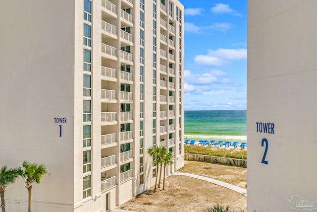 exterior space featuring a view of the beach and a water view