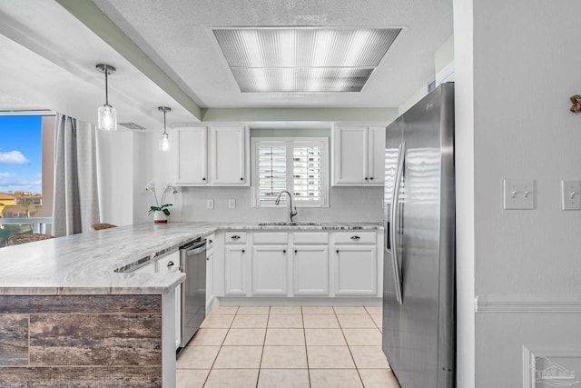 kitchen with kitchen peninsula, white cabinetry, sink, and stainless steel appliances