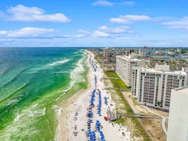 drone / aerial view featuring a beach view and a water view