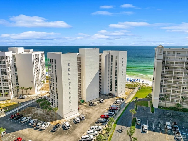 drone / aerial view featuring a water view and a view of the beach