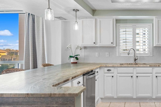 kitchen featuring kitchen peninsula, decorative light fixtures, sink, and white cabinets