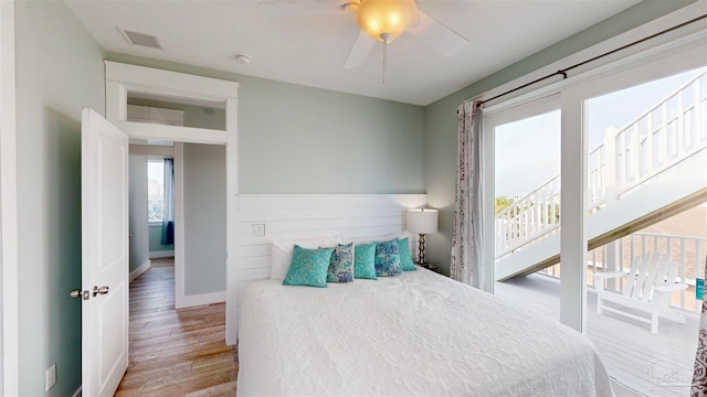 bedroom with multiple windows, ceiling fan, and light hardwood / wood-style flooring