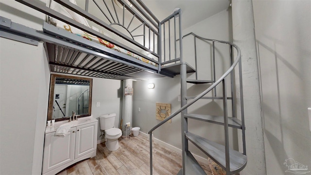 stairs with wood-type flooring and sink