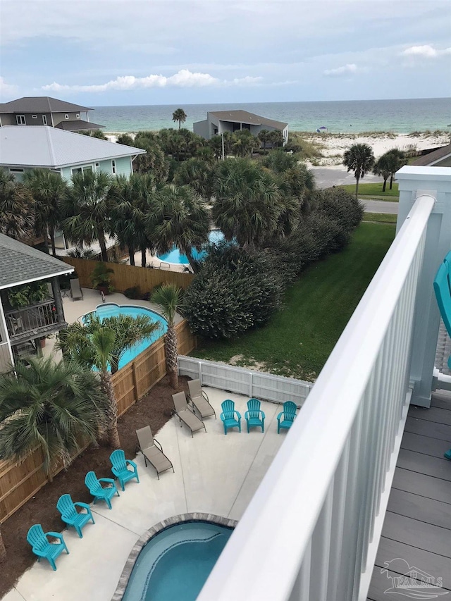 view of swimming pool with a water view and a patio