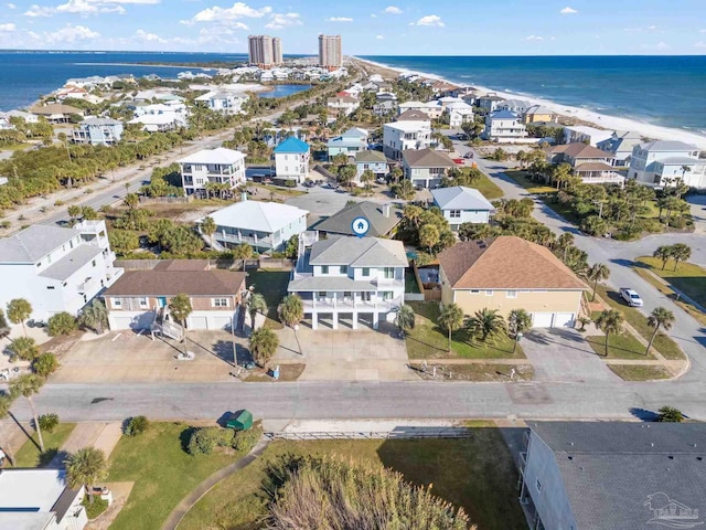 birds eye view of property with a water view and a view of the beach