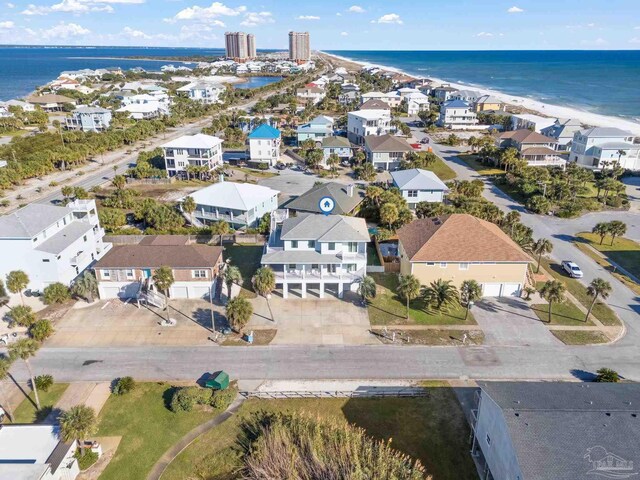 birds eye view of property featuring a water view and a beach view