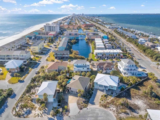 bird's eye view with a water view and a beach view