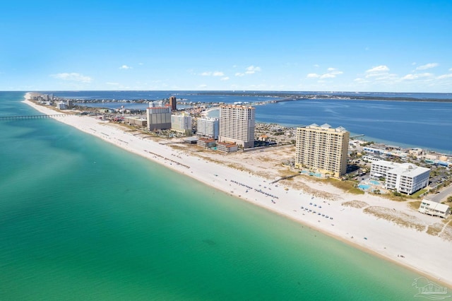 drone / aerial view with a water view and a beach view