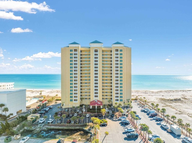 exterior space featuring a water view and a beach view