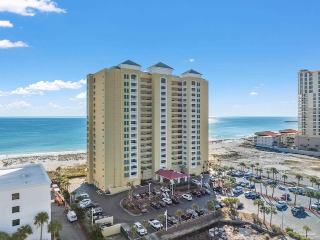 exterior space featuring a water view and a beach view