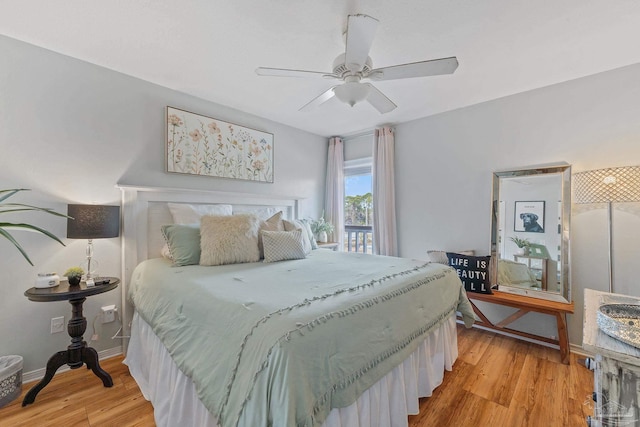 bedroom featuring light wood finished floors, a ceiling fan, and baseboards