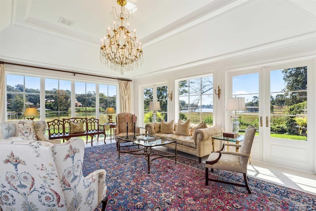 sunroom / solarium with a notable chandelier