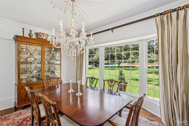 dining space featuring crown molding, a chandelier, and hardwood / wood-style floors