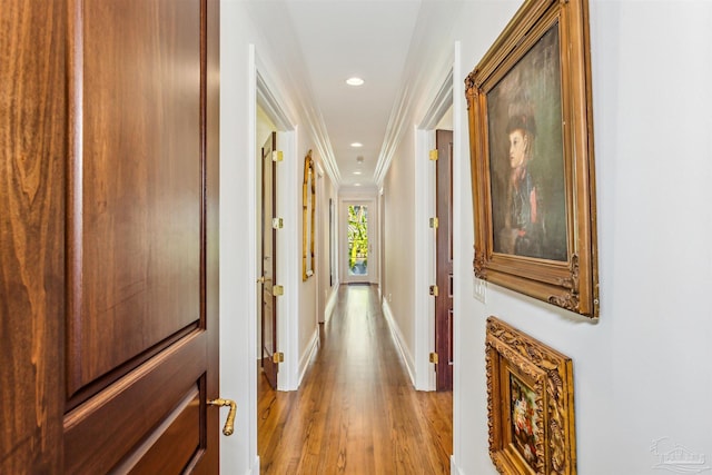 hall featuring light hardwood / wood-style flooring and ornamental molding