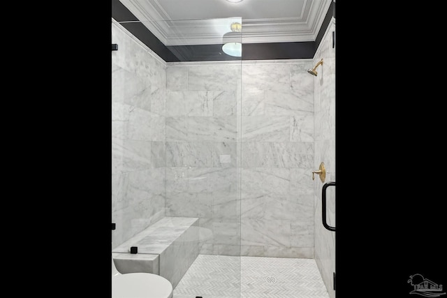 bathroom featuring a shower with door, ornamental molding, and toilet