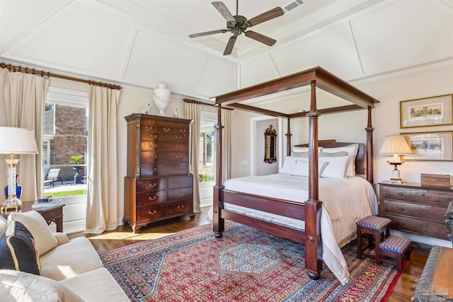 bedroom with multiple windows, hardwood / wood-style floors, ornamental molding, and coffered ceiling