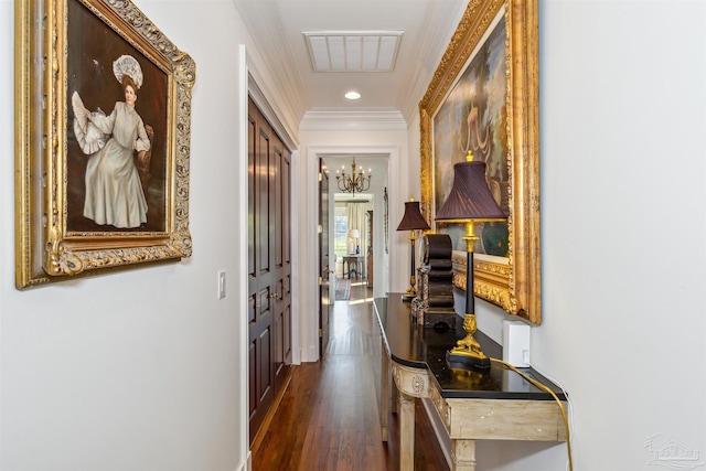 corridor with crown molding, dark hardwood / wood-style floors, and a notable chandelier