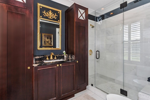 bathroom featuring vanity and a shower with shower door