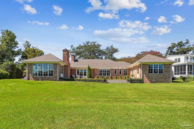 rear view of house with a yard