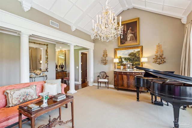 sitting room with carpet floors, a chandelier, vaulted ceiling, and ornate columns