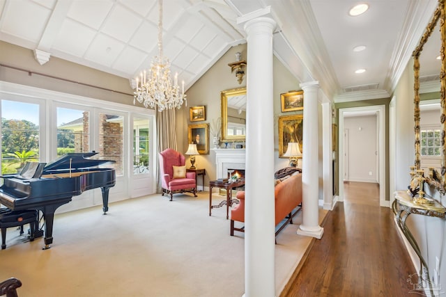 living area featuring crown molding, decorative columns, and a healthy amount of sunlight