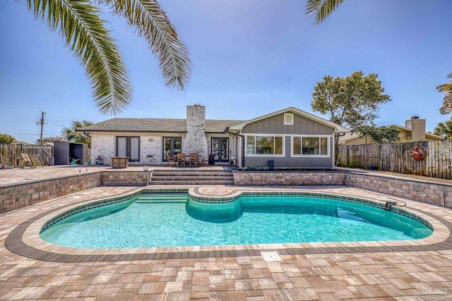 view of swimming pool featuring a fenced in pool, french doors, a patio, and fence