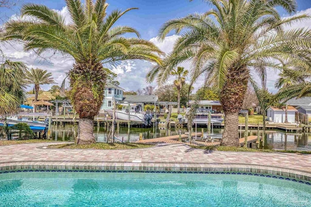 pool featuring a dock and a water view