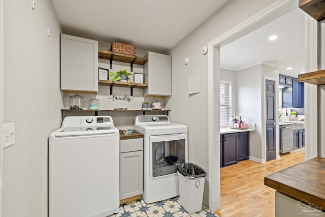 laundry room with baseboards, recessed lighting, cabinet space, washer and dryer, and crown molding