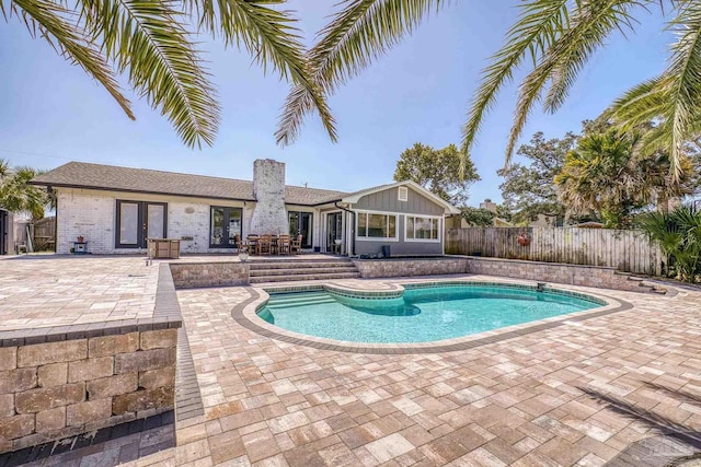 view of swimming pool featuring a fenced in pool, french doors, a patio, and fence