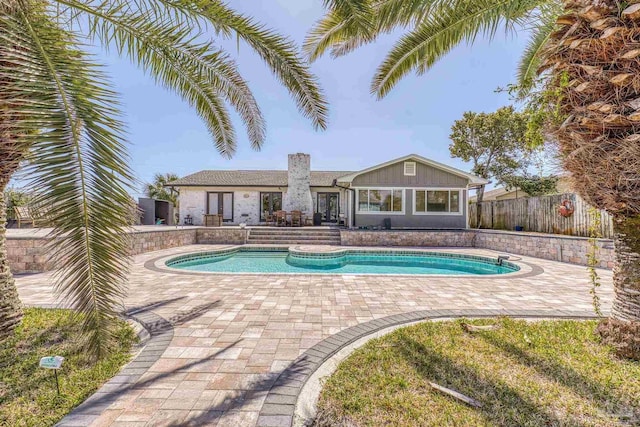 view of swimming pool with a fenced in pool, french doors, a patio, and fence