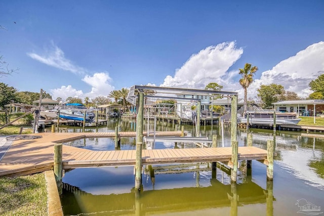 dock area with boat lift and a water view