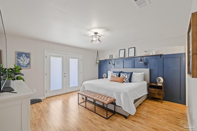 bedroom with visible vents, access to outside, french doors, light wood finished floors, and baseboards