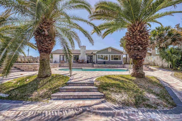 outdoor pool featuring fence