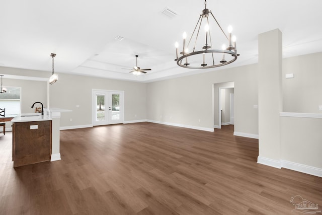 5681 Paddlewheel Dr, Milton, FL 32583 - unfurnished living room featuring a chandelier, a raised ceiling, dark wood finished floors, and a sink