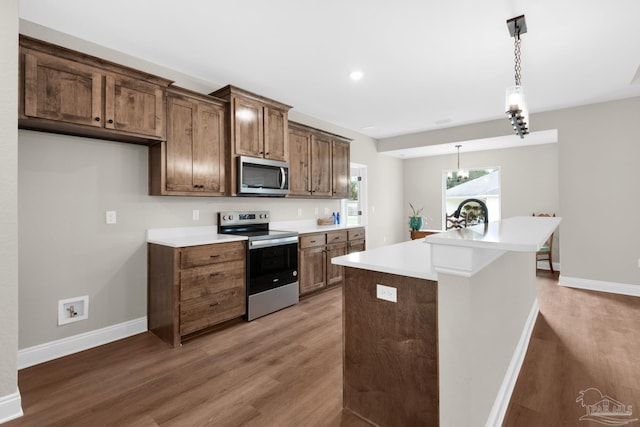 5681 Paddlewheel Dr, Milton, FL 32583 - kitchen with stainless steel appliances, wood finished floors, light countertops, and recessed lighting
