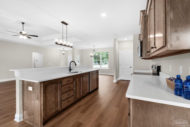 5681 Paddlewheel Dr, Milton, FL 32583 - kitchen with stove, dishwasher, a sink, dark wood-style floors, and a center island with sink